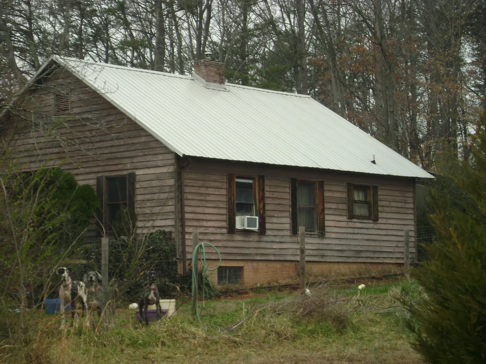 White metal roof on an old wood sided farmhouse, from a Metal Roof Installation job in Flintville
